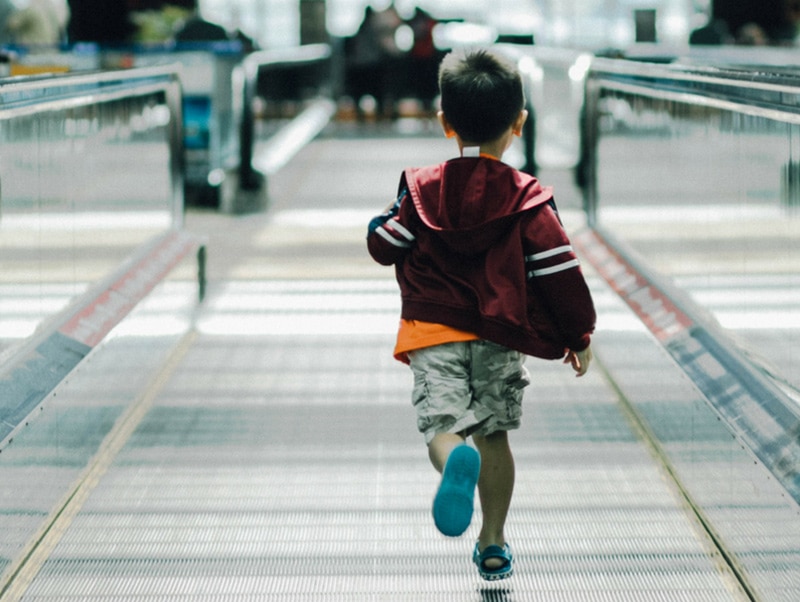 young child running in an airport