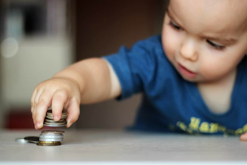 Baby picking up coins